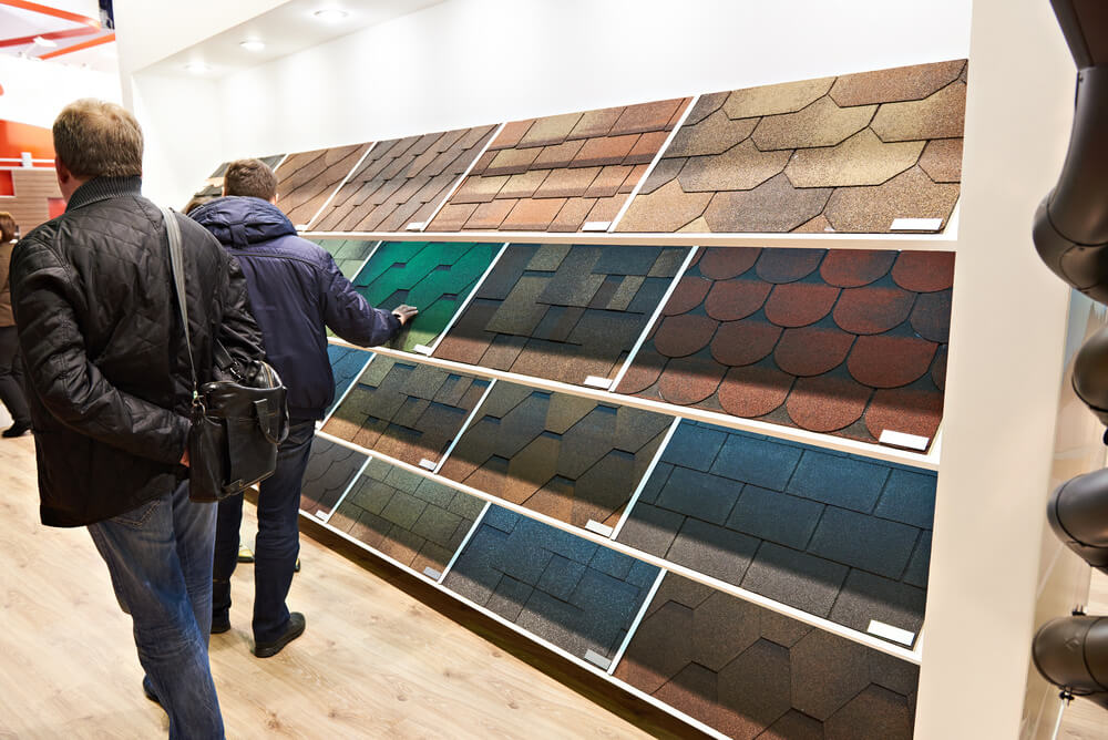 Buyers in construction shop choose soft roof tiles