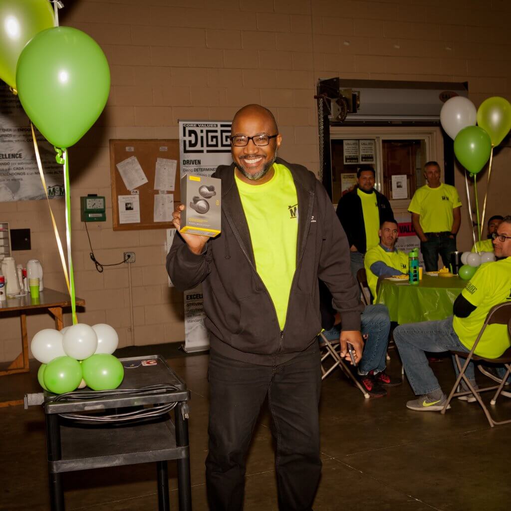 m-m employee holding a headphone