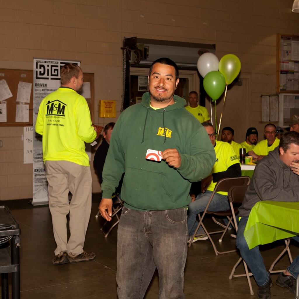 m-m employee holding a gift card