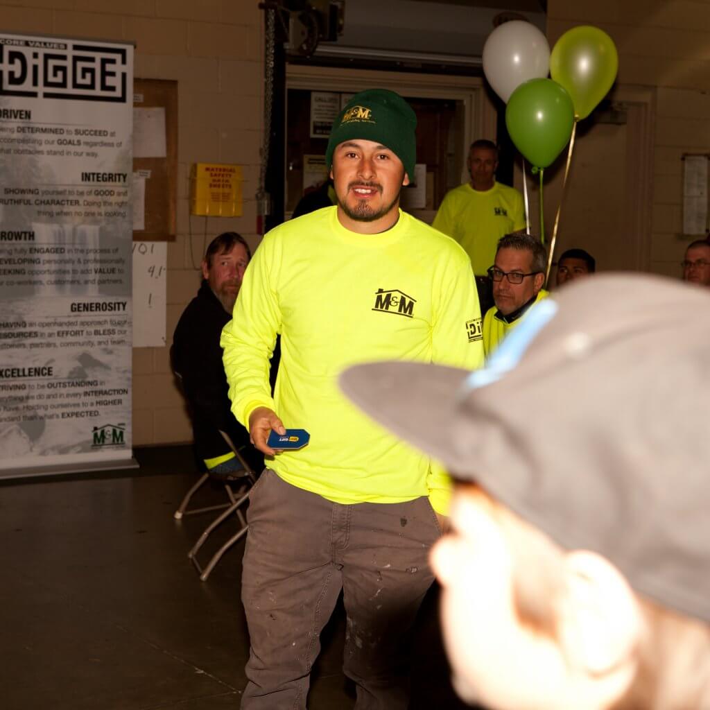 m-m employee holding a best buy gift card