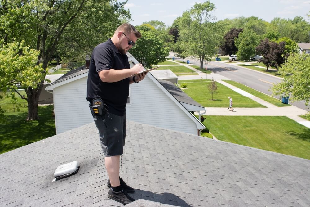 man inspecting the roof