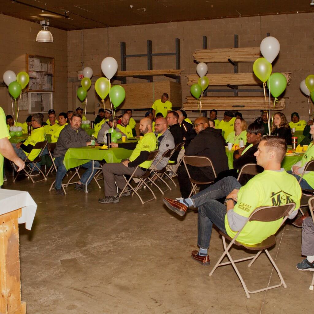 m-m employees sitting and listening 
