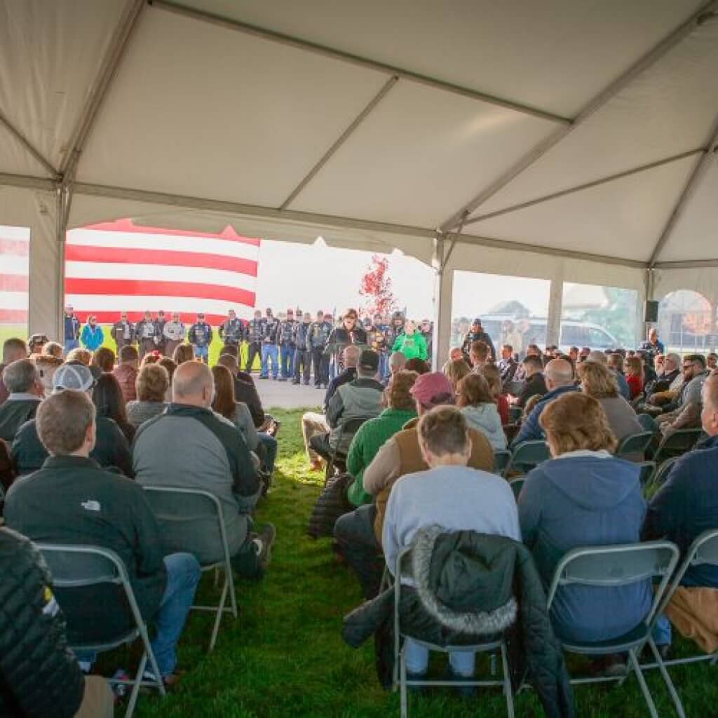 people sitting and listening to the woman infront of them
