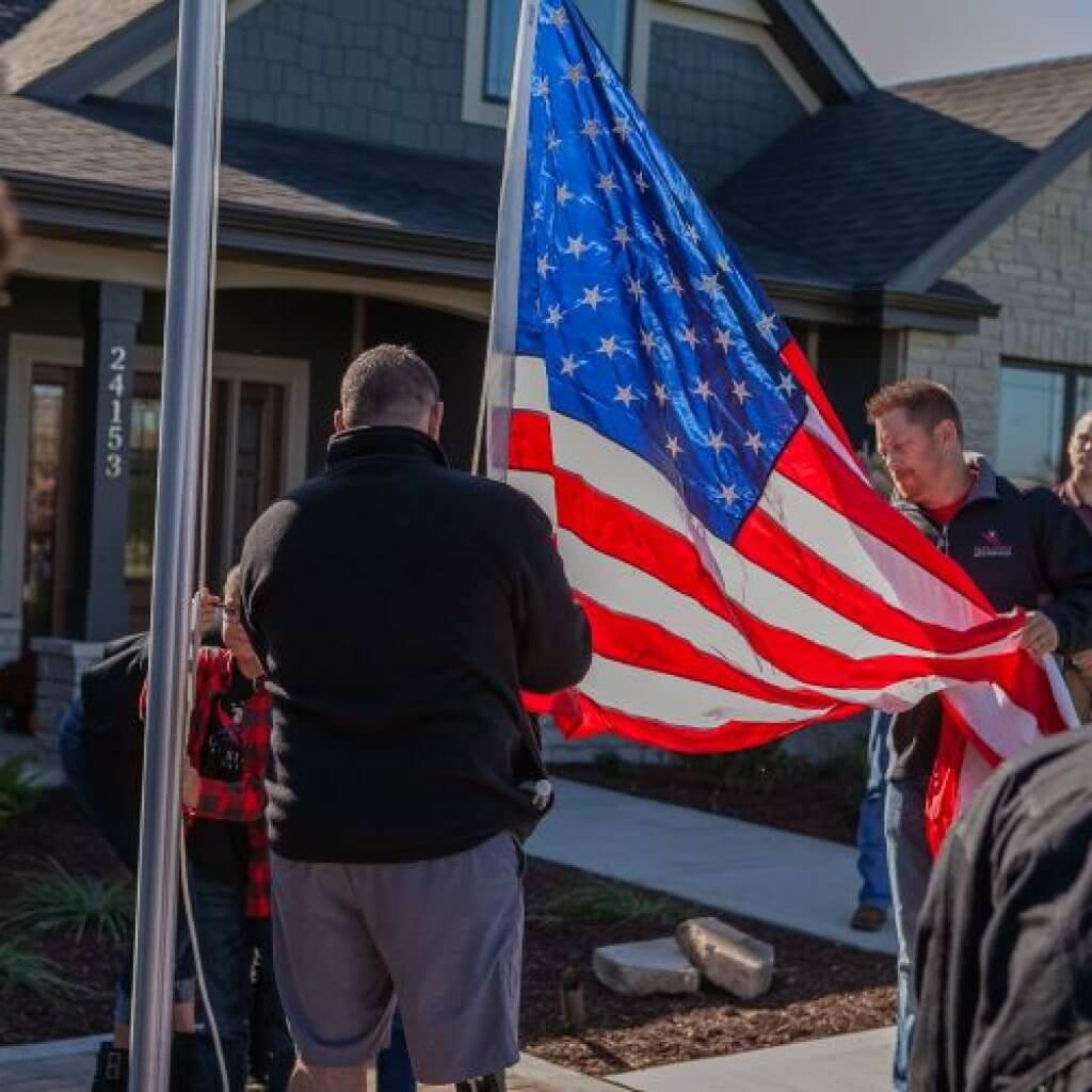 two men holding american flag