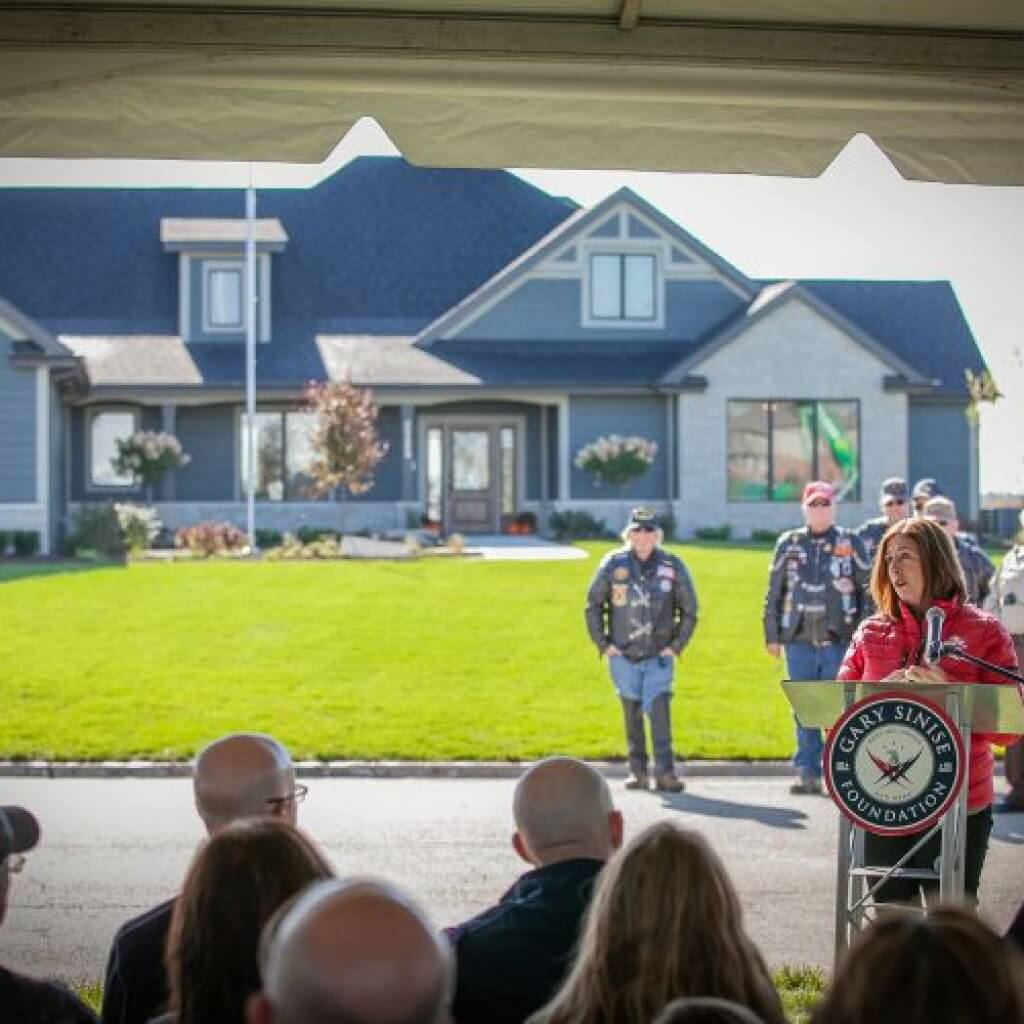 woman speaking infront of the crow