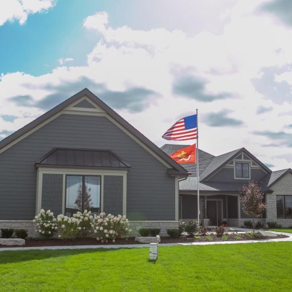 gray house with two flags