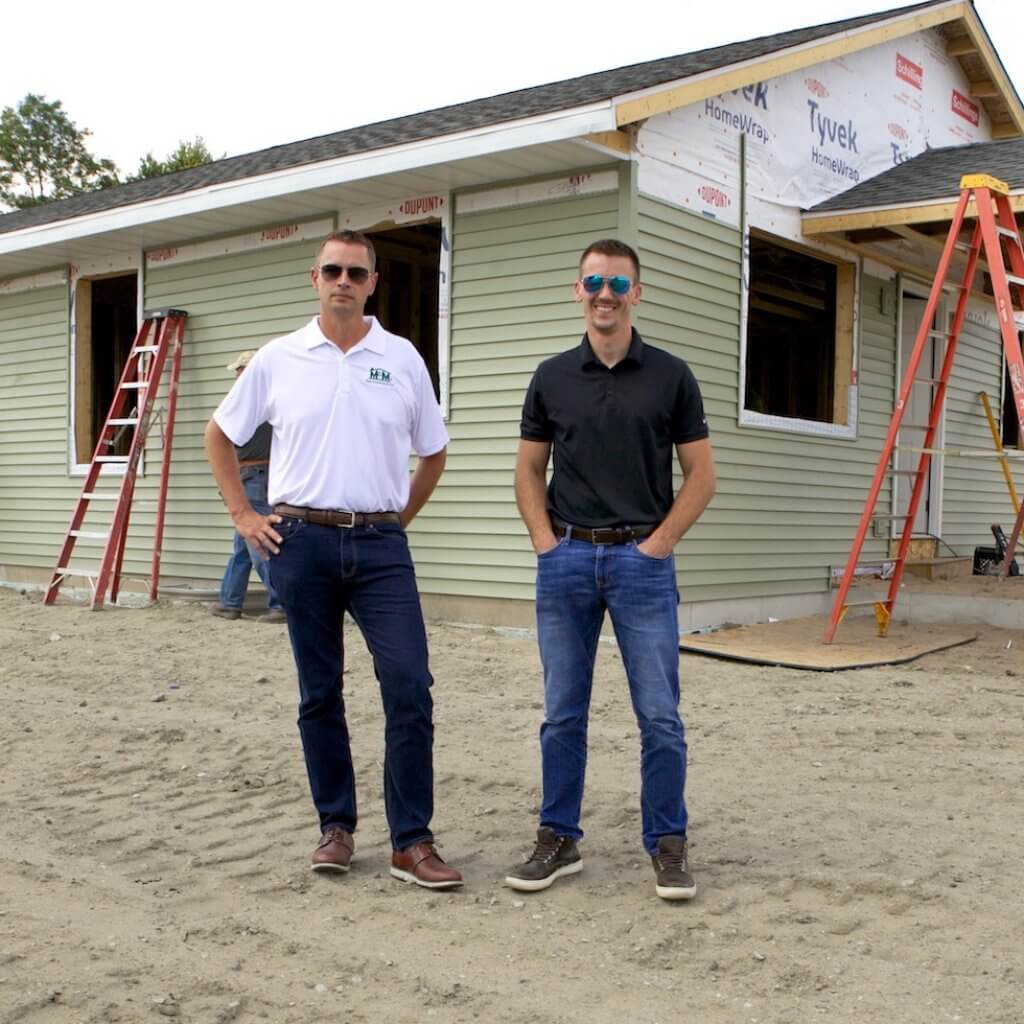 two man in front the house